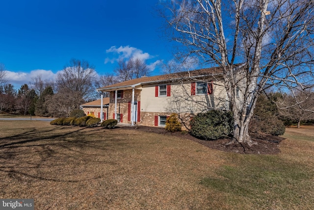 raised ranch with a front lawn