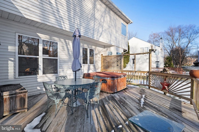 wooden deck featuring a hot tub