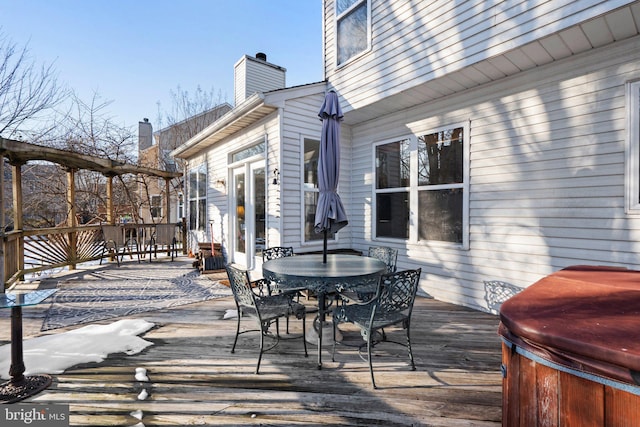 wooden terrace featuring a hot tub