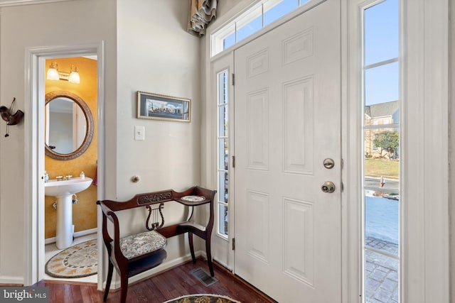 entryway with dark hardwood / wood-style flooring