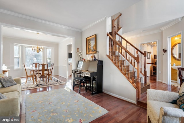 living room with an inviting chandelier, crown molding, and dark hardwood / wood-style floors