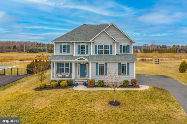 view of front of home with a porch and a front lawn