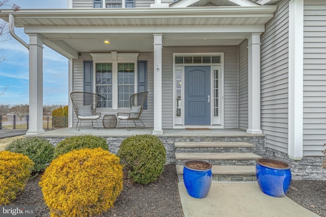 doorway to property featuring covered porch