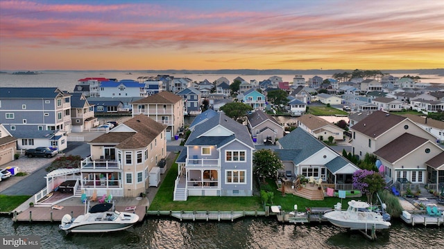 aerial view at dusk with a water view