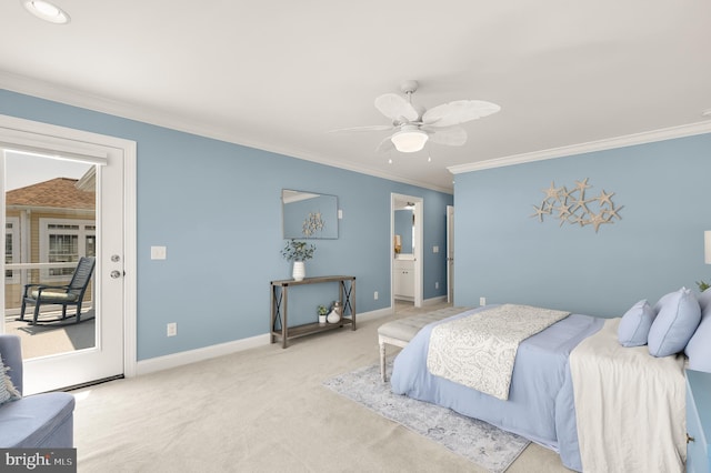 carpeted bedroom featuring ensuite bath, ornamental molding, and ceiling fan