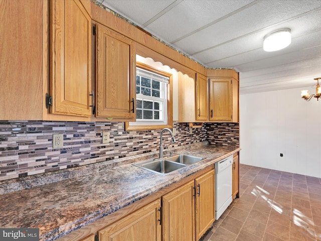 kitchen featuring sink, white dishwasher, decorative backsplash, tile patterned floors, and a chandelier