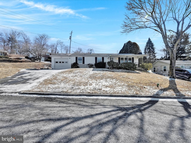 single story home with a garage and covered porch