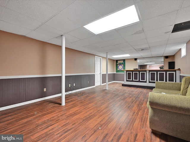 basement featuring dark hardwood / wood-style floors and a drop ceiling