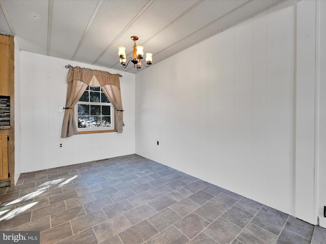 unfurnished dining area featuring an inviting chandelier