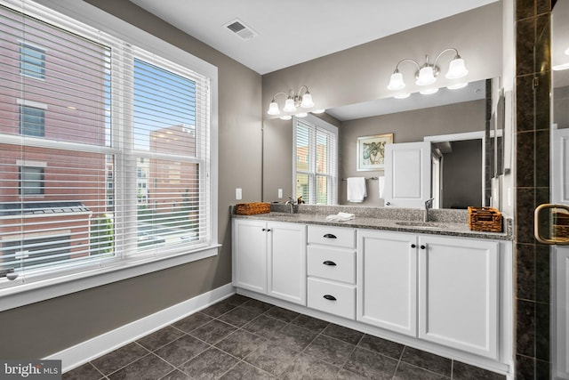 full bathroom with visible vents, baseboards, double vanity, a sink, and tile patterned flooring