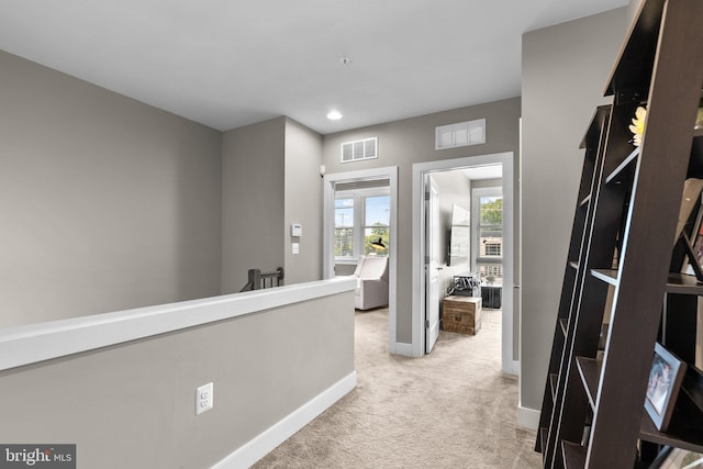 corridor with visible vents, light carpet, an upstairs landing, recessed lighting, and baseboards