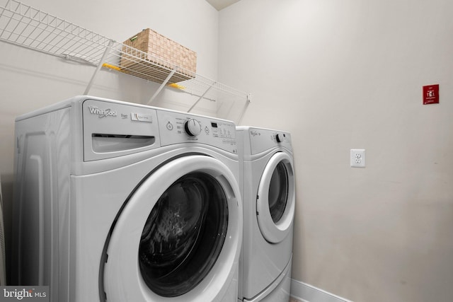 laundry area with baseboards, independent washer and dryer, and laundry area