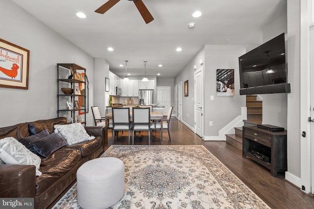 living area with a ceiling fan, stairway, recessed lighting, and dark wood-style flooring