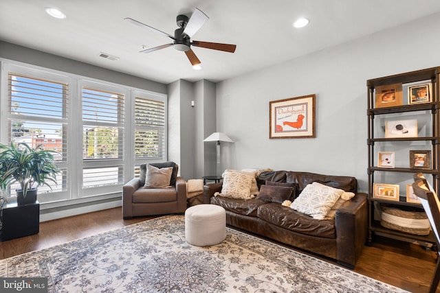 living room with recessed lighting, wood finished floors, and visible vents