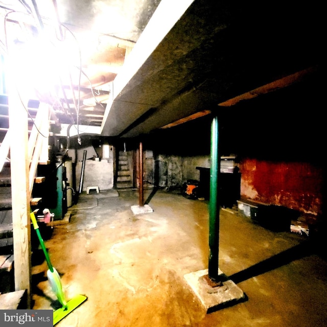 unfinished basement featuring stairway