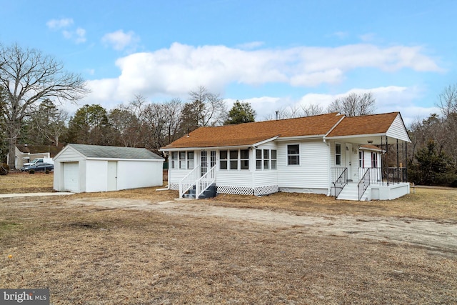 view of front of property with an outbuilding and a garage