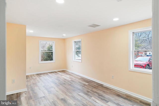 unfurnished room with a wealth of natural light and light wood-type flooring