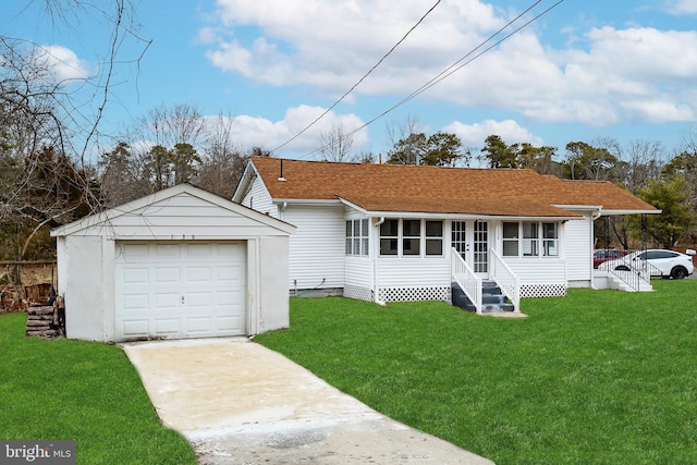 back of property with a garage, a yard, and an outbuilding