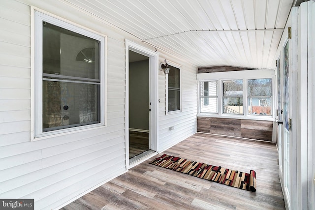 sunroom / solarium with wood ceiling and lofted ceiling