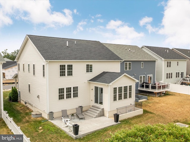 back of house featuring a yard and a patio