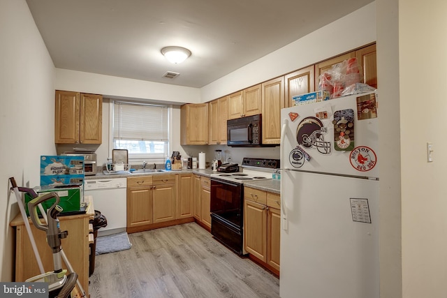 kitchen featuring sink, white appliances, and light hardwood / wood-style floors