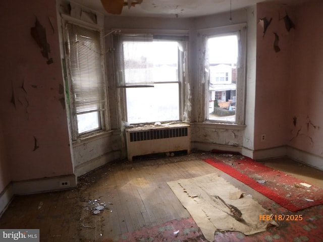 unfurnished room with wood-type flooring and radiator