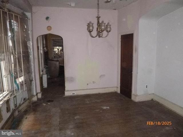 unfurnished dining area with an inviting chandelier