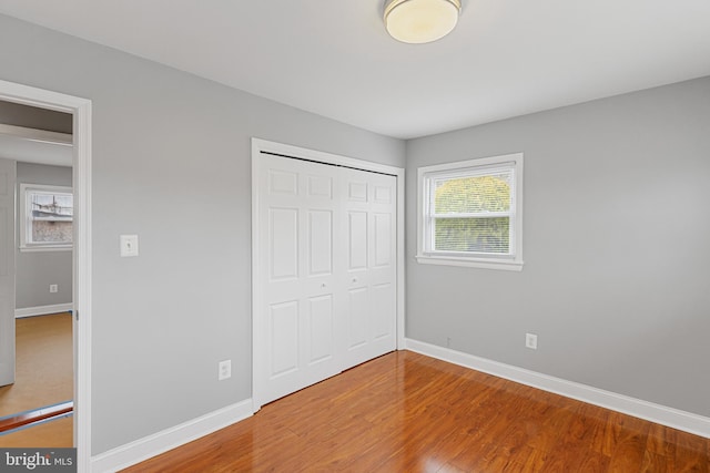 unfurnished bedroom with baseboards and wood finished floors