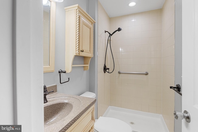 bathroom with vanity, a shower stall, toilet, and recessed lighting