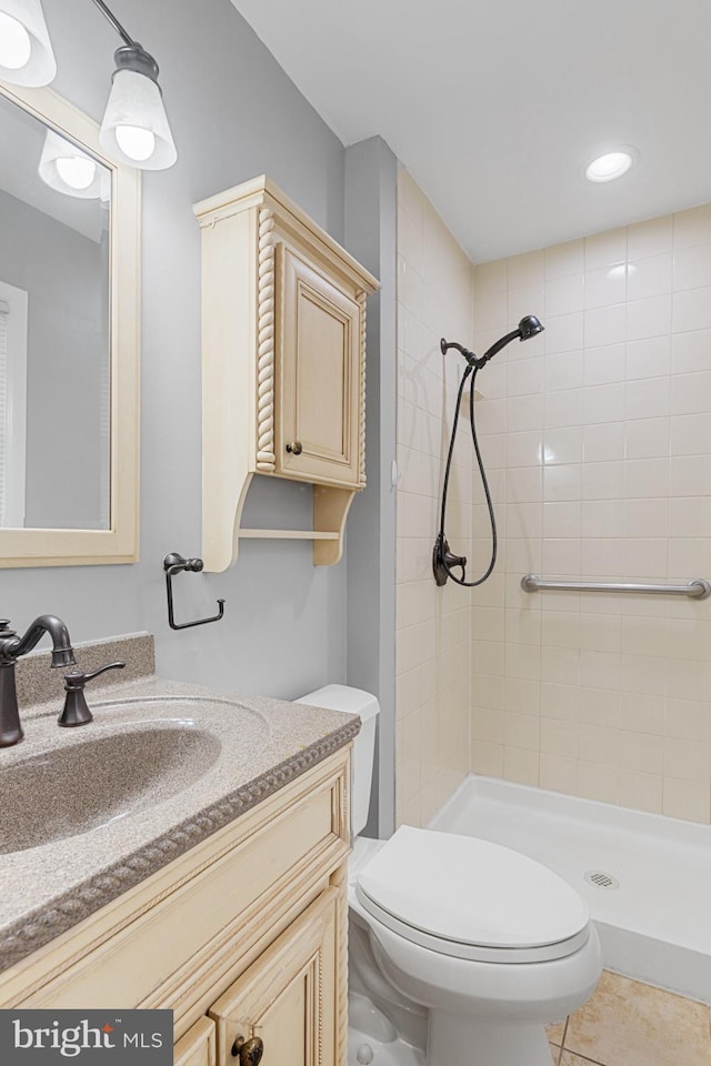 full bath with toilet, a shower stall, tile patterned flooring, and vanity