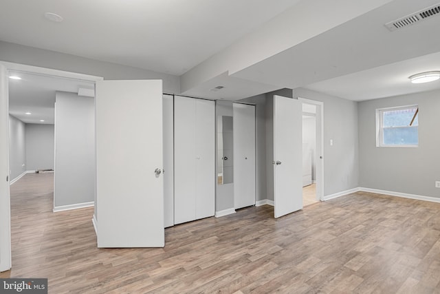 unfurnished bedroom featuring light wood-style flooring, visible vents, and baseboards