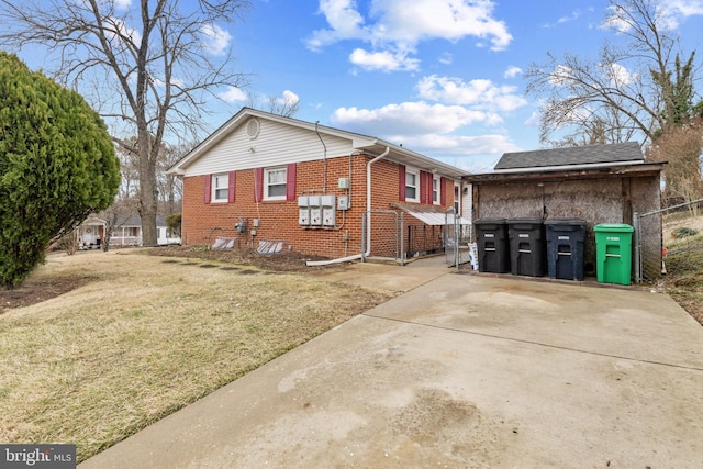 view of home's exterior featuring brick siding and a yard