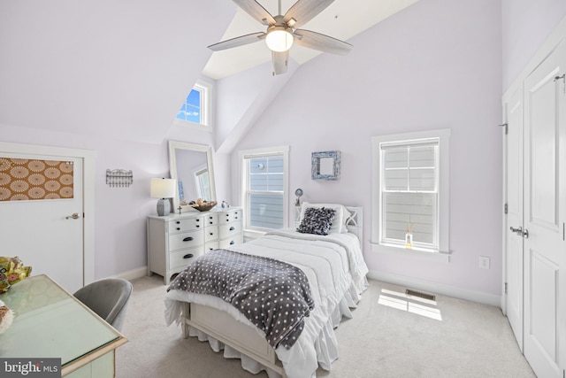 carpeted bedroom featuring ceiling fan and high vaulted ceiling