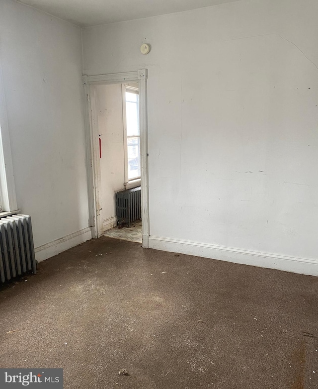 unfurnished room featuring radiator