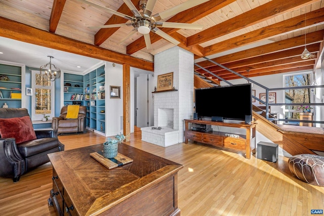 living room with beamed ceiling, wooden ceiling, ceiling fan with notable chandelier, and light wood-type flooring