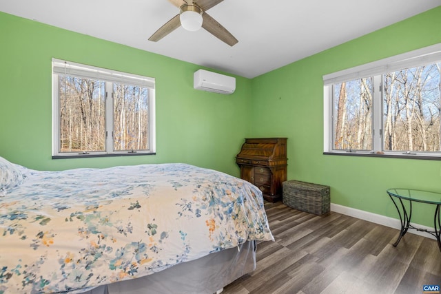 bedroom featuring hardwood / wood-style floors, a wall mounted air conditioner, and ceiling fan