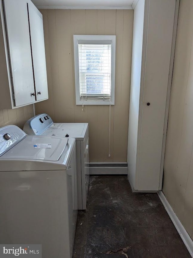 laundry area featuring cabinets, washing machine and clothes dryer, and baseboard heating