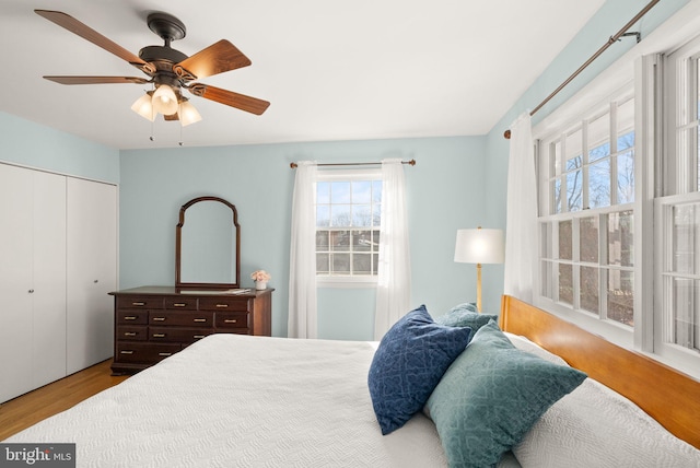 bedroom featuring a closet, a ceiling fan, and wood finished floors