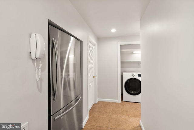 laundry room featuring recessed lighting, light tile patterned flooring, baseboards, washer / dryer, and laundry area