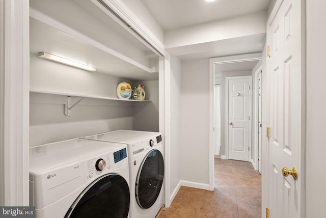 laundry area featuring light tile patterned floors, baseboards, laundry area, and washing machine and clothes dryer