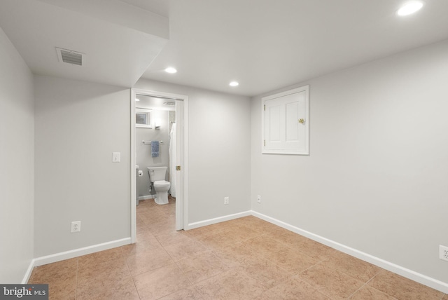 unfurnished bedroom featuring light tile patterned floors, visible vents, baseboards, ensuite bath, and recessed lighting