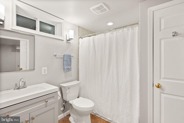 bathroom featuring tile patterned flooring, visible vents, baseboards, toilet, and vanity