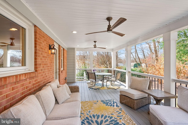 wooden terrace featuring outdoor lounge area and a ceiling fan