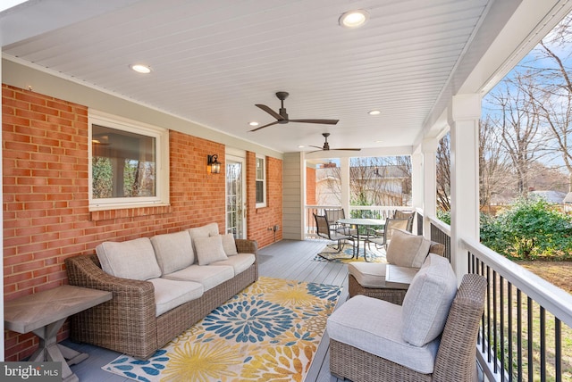 wooden terrace with outdoor lounge area, outdoor dining area, and a ceiling fan