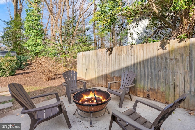 view of patio with an outdoor fire pit and fence