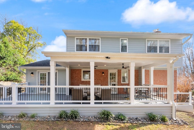 american foursquare style home with brick siding and a ceiling fan