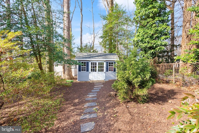 exterior space featuring an outbuilding and fence