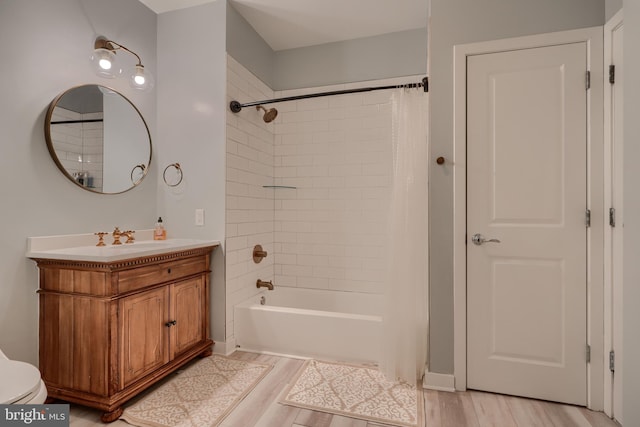 bathroom with hardwood / wood-style flooring, shower / tub combo with curtain, and vanity