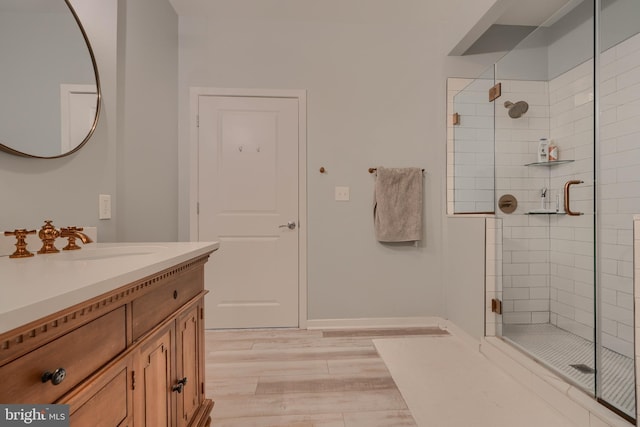 bathroom featuring vanity, hardwood / wood-style floors, and an enclosed shower