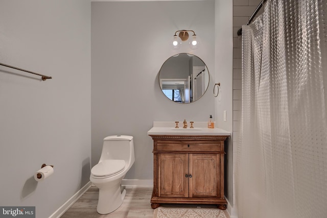 bathroom featuring vanity, wood-type flooring, toilet, and walk in shower